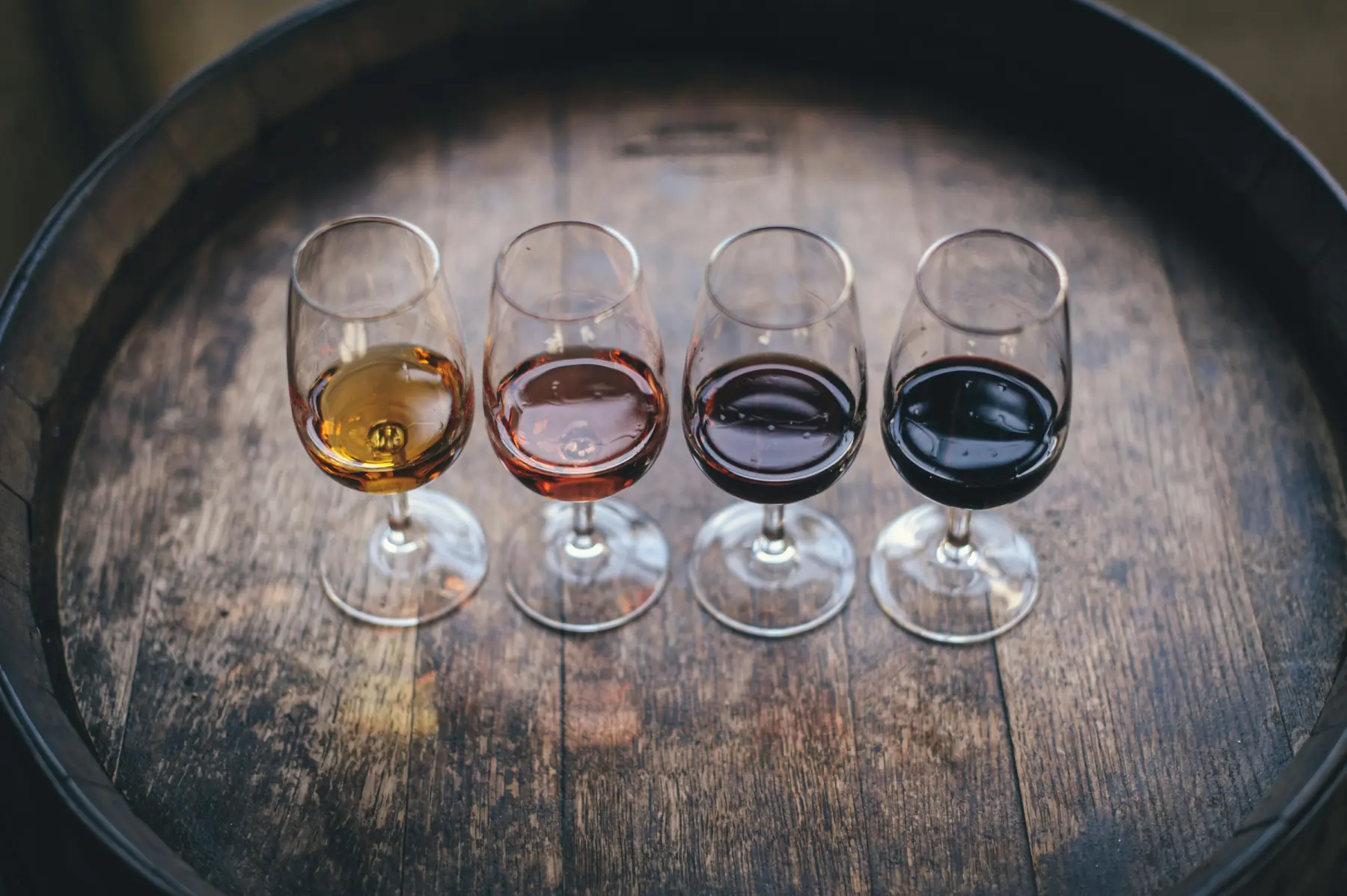 A tasting table with glasses and bottles in natural light